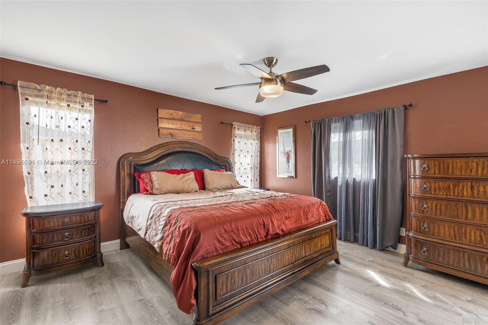 775 Arundel Circle Fort Myers, FL 33913 - Photo 7 of 26 a bedroom with a bed a dresser and book shelfs
