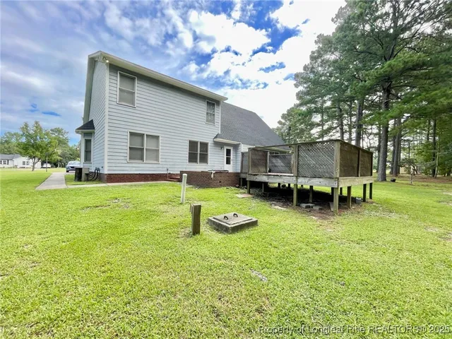 a view of a house with a backyard