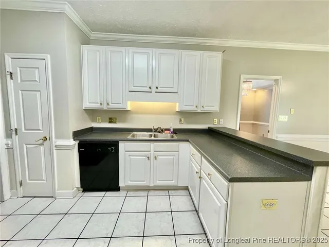 a kitchen with a sink and a stove top oven