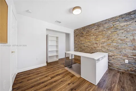 a view of a livingroom with wooden floor and staircase