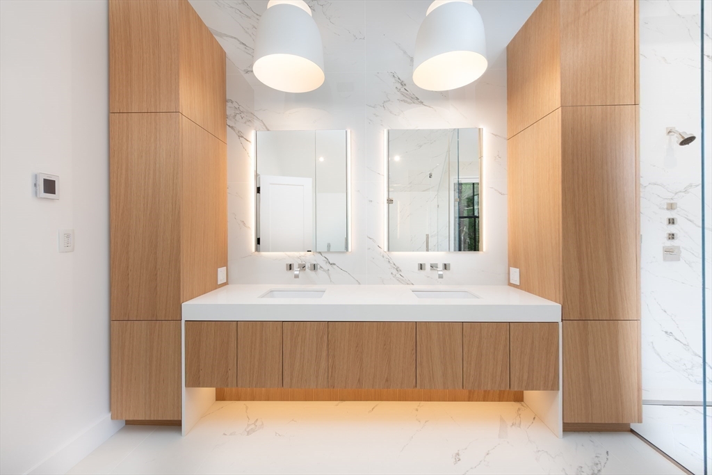 39 Westfield Road Newton, MA 02465 - Photo 27 of 42 a bathroom with a double vanity sink and a mirror