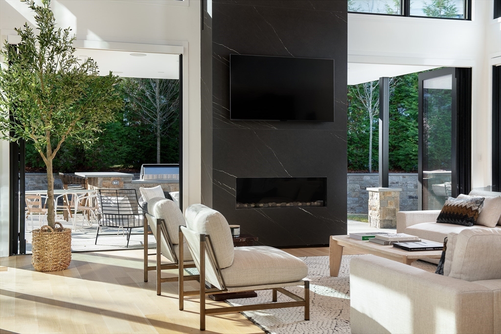 39 Westfield Road Newton, MA 02465 - Photo 8 of 42 a outdoor space with patio the couches and a fireplace