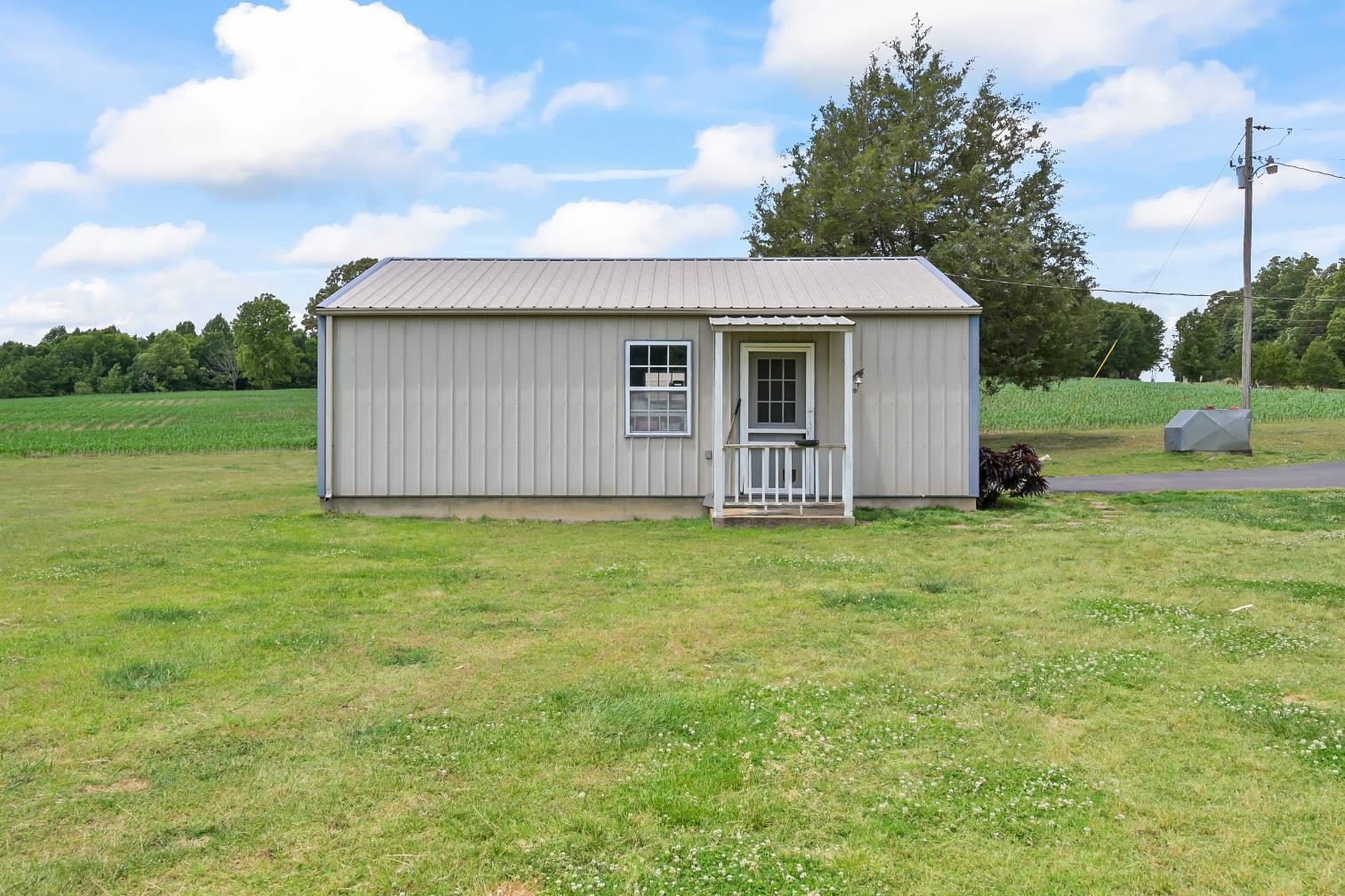 6439 Cedar Grove Road Big Sandy, TN 38221 - Photo 23 of 38 a view of a house with backyard and garden