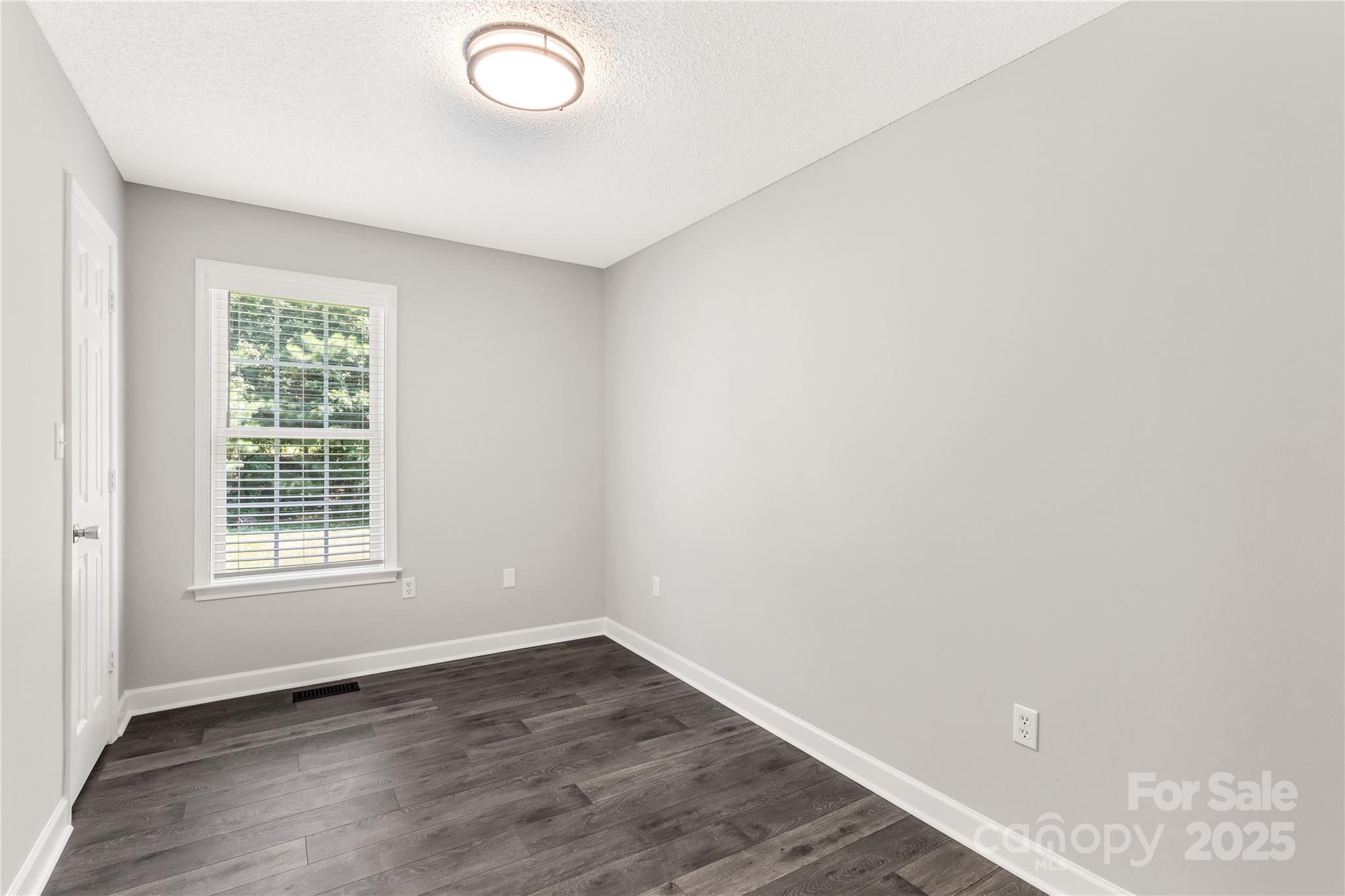 1675 Old Lynwood Circle Lancaster, SC 29720 - Photo 17 of 32 an empty room with wooden floor and windows