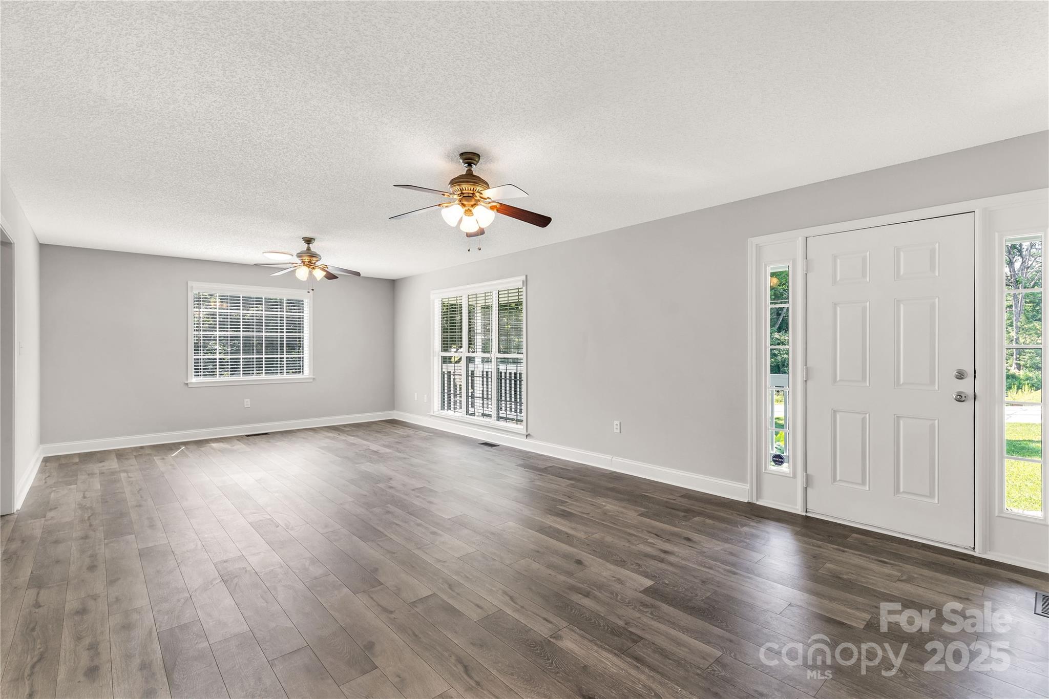 1675 Old Lynwood Circle Lancaster, SC 29720 - Photo 10 of 32 an empty room with wooden floor chandelier and windows