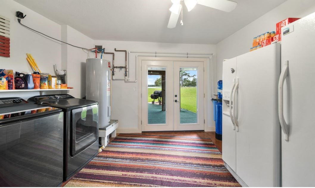 6714 Spray Lane, Unit C699A Rosharon, TX 77583 - Photo 13 of 48 1st Floor utility room with Convenient Access to the Back Patio. Perfectly located for keeping outdoor dirt away from your living areas. As you can see plenty of room for Extra Fridge & Freezer