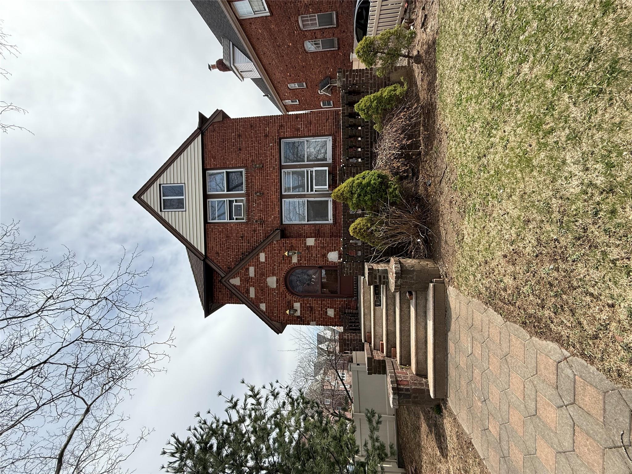 View of front facade featuring brick siding