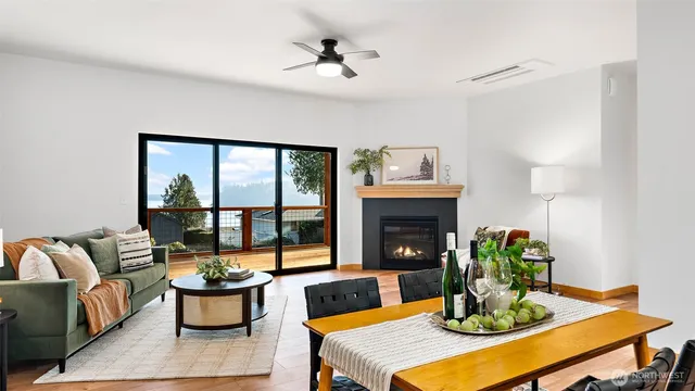 a living room with furniture a fireplace and a table