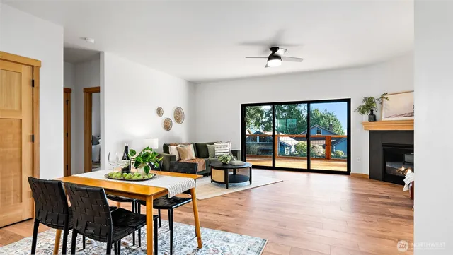 a living room with furniture a fireplace and a floor to ceiling window