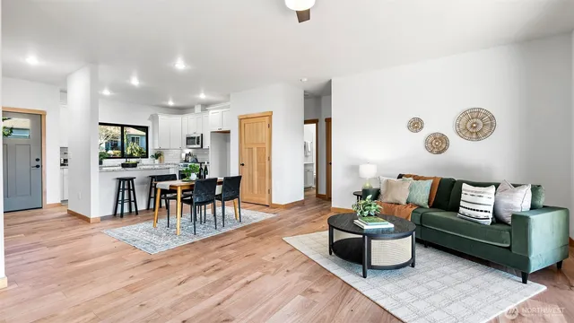 a living room with furniture and wooden floor