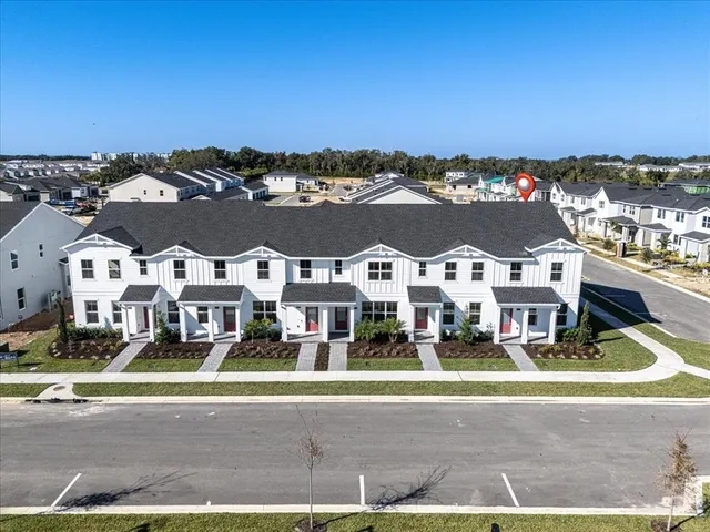 a living room with furniture a flat screen tv and a window