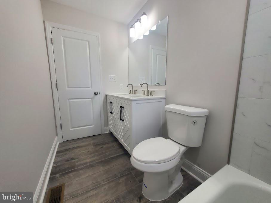 336 Pardee Boulevard Browns Mills, NJ 08015 - Photo 16 of 32 a bathroom with a toilet a sink and mirror