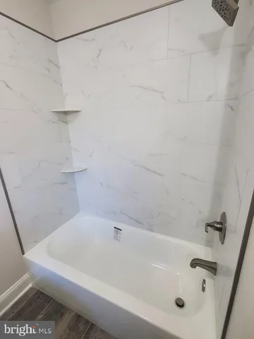 a white bath tub and a shower
