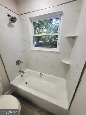 a white bath tub sitting next to a window