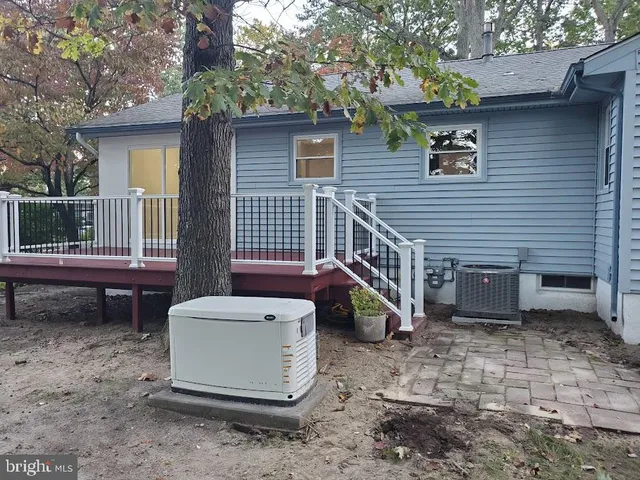 a view of a patio with a table and chairs and a barbeque