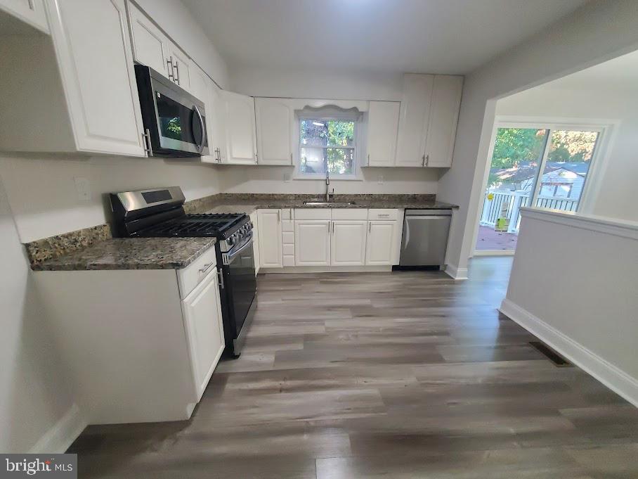 336 Pardee Boulevard Browns Mills, NJ 08015 - Photo 3 of 32 a kitchen with stainless steel appliances granite countertop a stove a sink and a microwave
