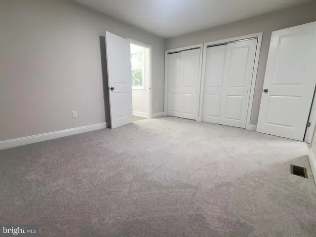 a view of an empty room and closet area