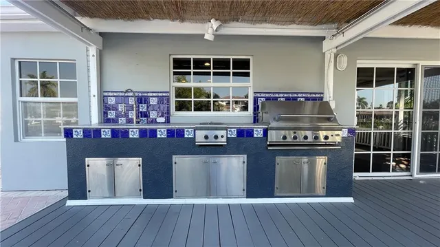 a kitchen with stainless steel appliances granite countertop a stove and a wooden floors