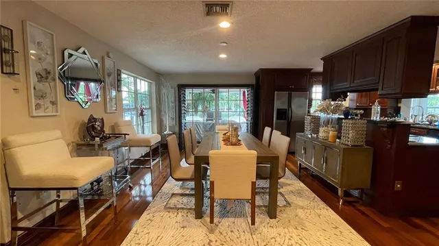 a view of a dining room with furniture window and wooden floor