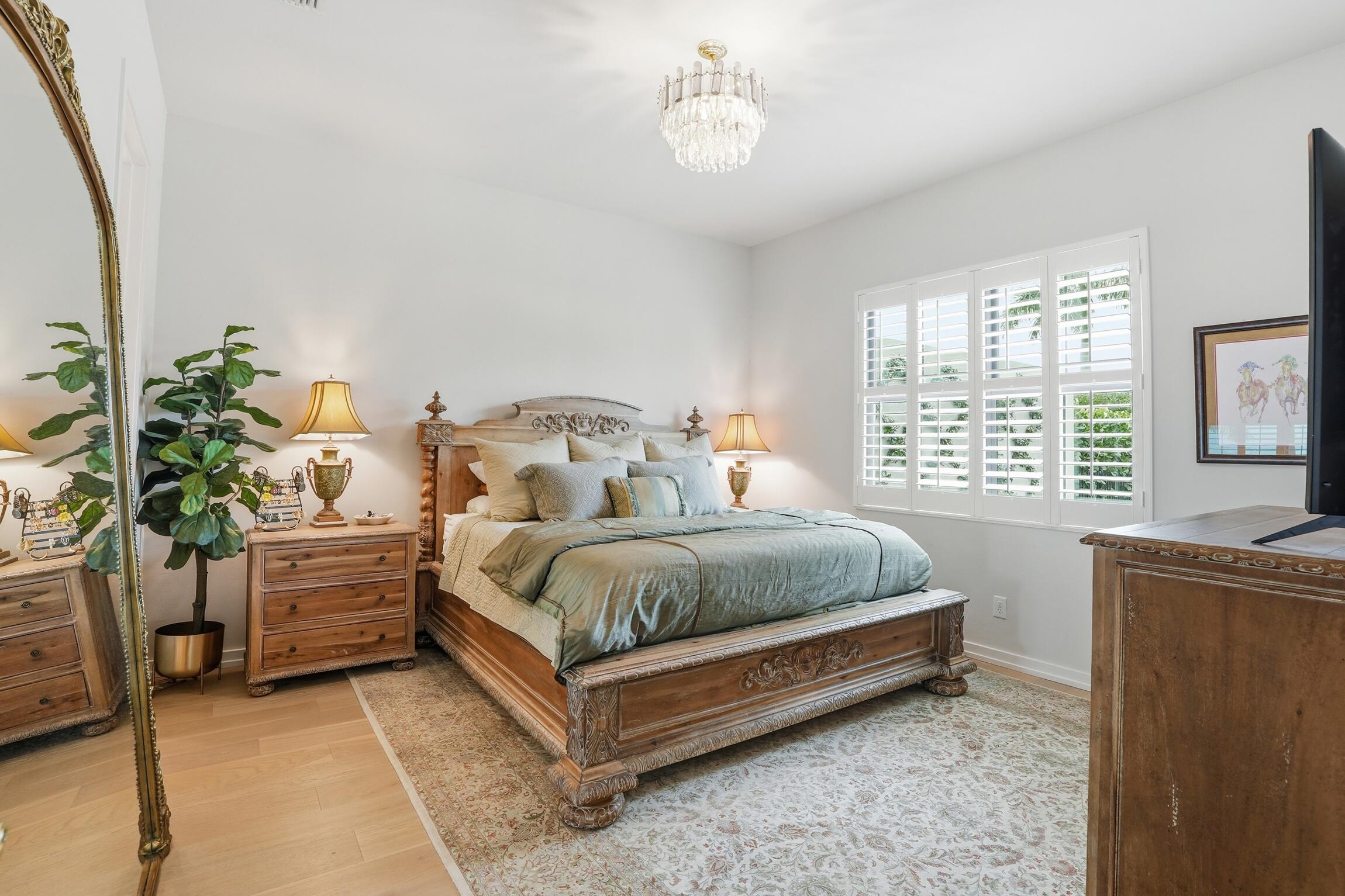 14708 Kingfisher Loop Naples, FL 34120 - Photo 18 of 42 a bedroom with a bed and a potted plant