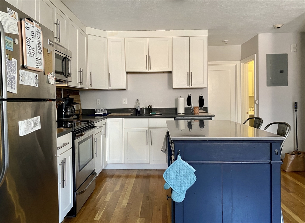 178 North Street, Unit 4 Boston, MA 02113 - Photo 2 of 8 a kitchen with stainless steel appliances granite countertop a sink a stove and cabinets