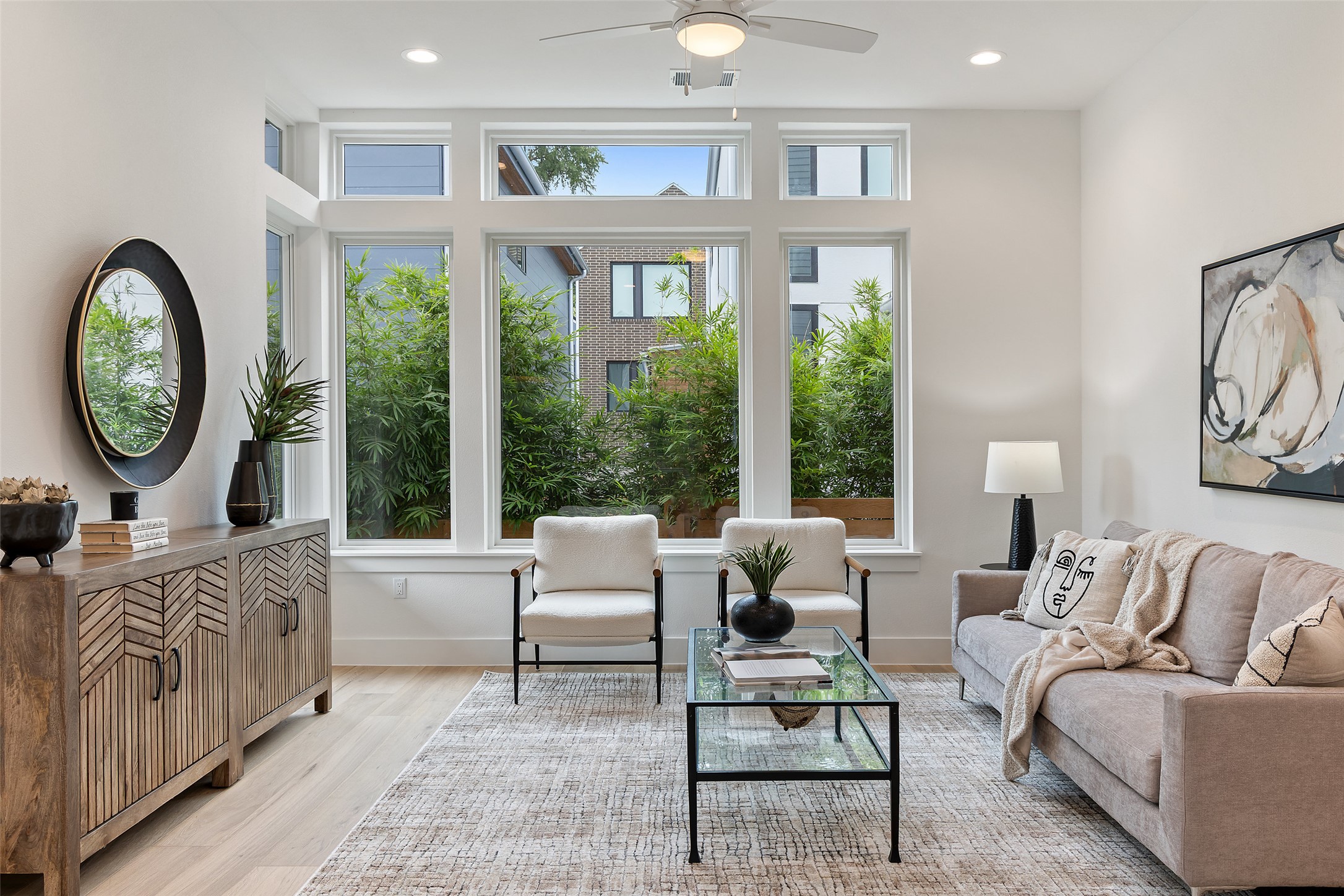 900 South 2nd Street, Unit 21 Austin, TX 78704 - Photo 13 of 25 a living room with furniture a large window and a clock