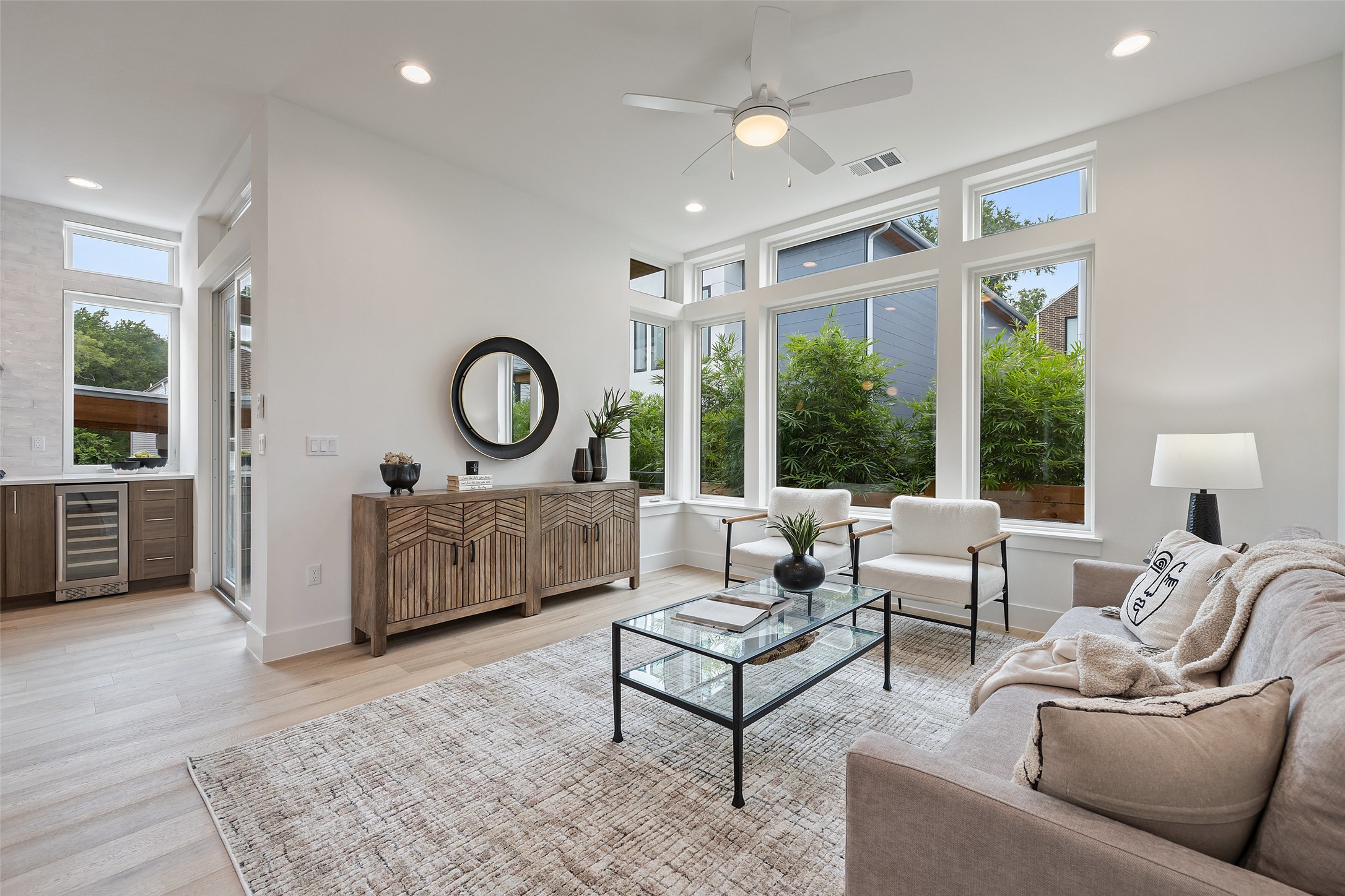 900 South 2nd Street, Unit 21 Austin, TX 78704 - Photo 14 of 25 a living room with furniture a large window and a chandelier