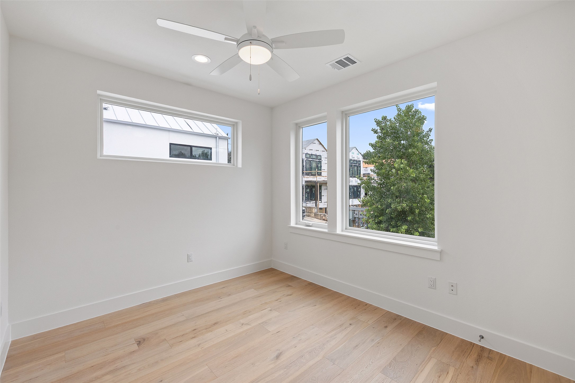 900 South 2nd Street, Unit 21 Austin, TX 78704 - Photo 21 of 25 an empty room with wooden floor and windows