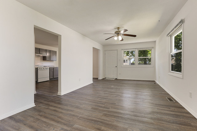 3237 Wallace Avenue Steger, IL 60475 - Photo 2 of 13 an empty room with wooden floor chandelier fan and windows