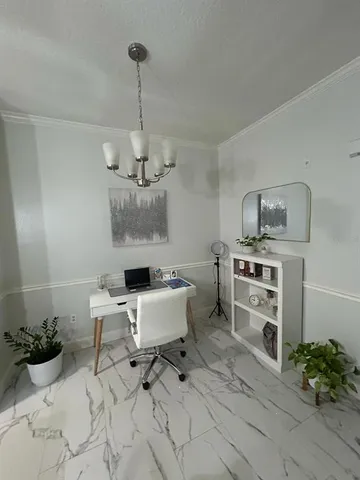 a workspace with furniture and a potted plant