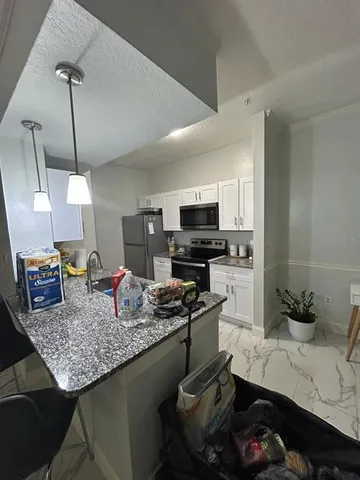 a kitchen with a counter space cabinets and appliances