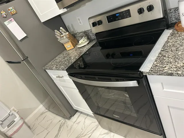 a view of living room with furniture and a fireplace