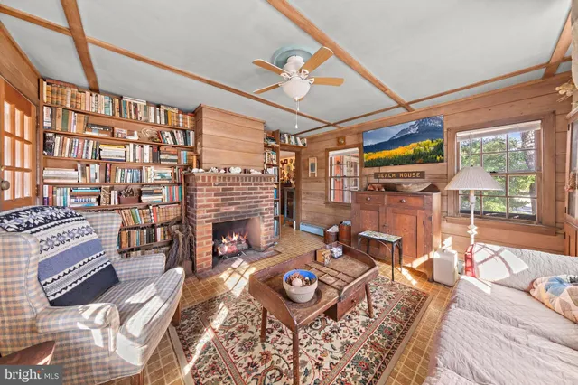 a living room with furniture ceiling fan and a rug