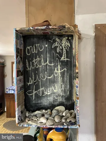 a living room with fireplace furniture and a large window