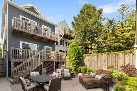 a backyard of a house with table and chairs
