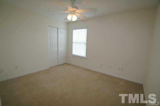 305 Rapp Lane Apex, NC 27502 - Photo 5 of 5 an empty room with a window and a fan