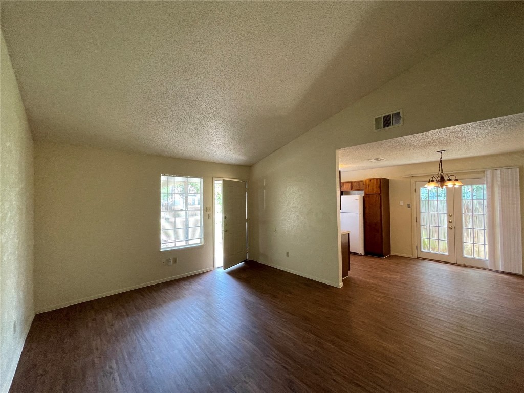 7902 Brodie Lane, Unit A Austin, TX 78745 - Photo 13 of 22 an empty room with wooden floor and windows