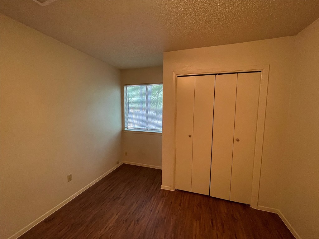 7902 Brodie Lane, Unit A Austin, TX 78745 - Photo 15 of 22 a view of an empty room with wooden floor