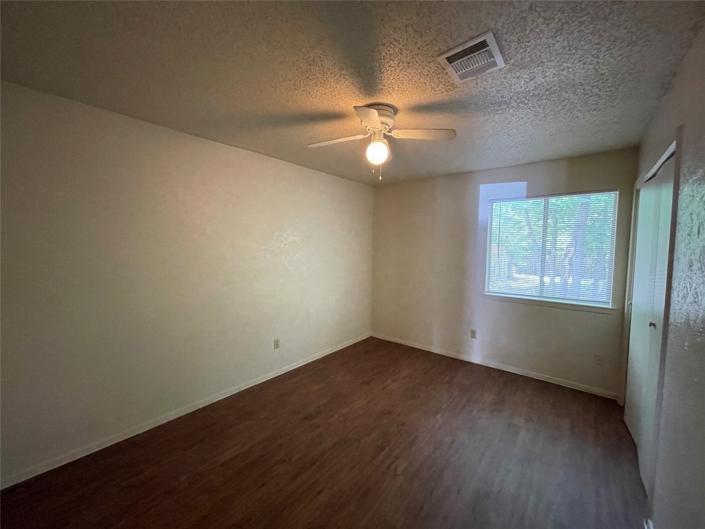 7902 Brodie Lane, Unit A Austin, TX 78745 - Photo 16 of 22 an empty room with wooden floor fan and windows