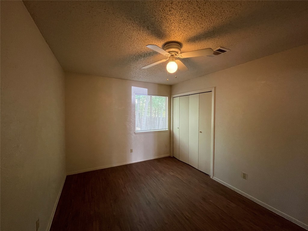 7902 Brodie Lane, Unit A Austin, TX 78745 - Photo 17 of 22 an empty room with wooden floor fan and windows