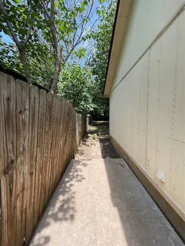 a view of backyard with wooden fence