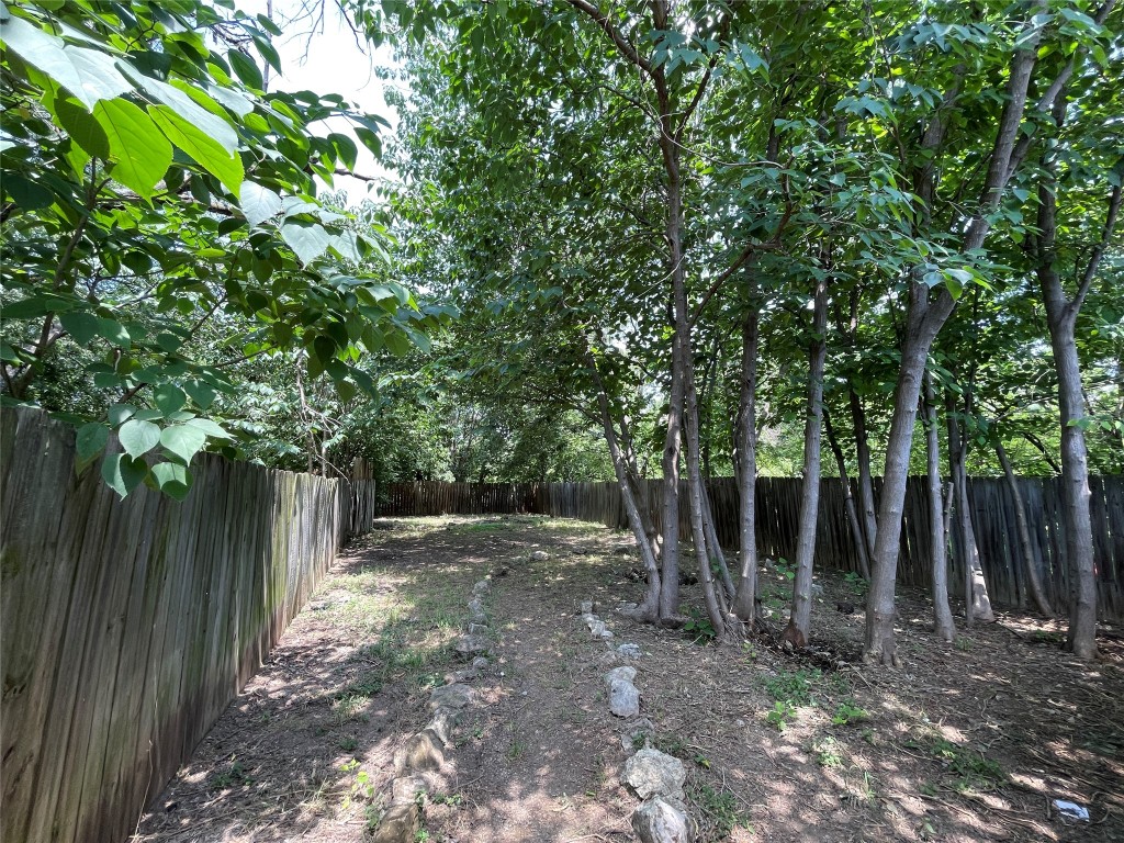 7902 Brodie Lane, Unit A Austin, TX 78745 - Photo 21 of 22 a view of a backyard with plants and large trees