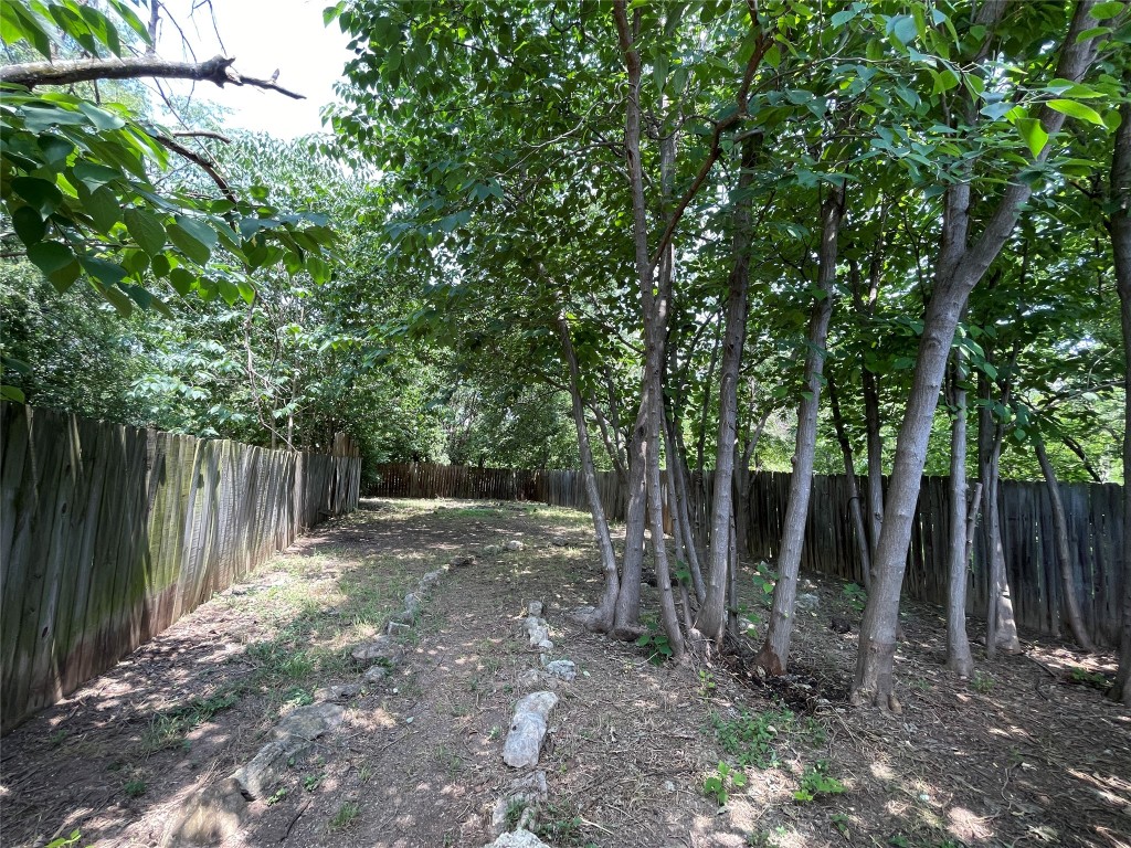 7902 Brodie Lane, Unit A Austin, TX 78745 - Photo 22 of 22 a backyard of a house with lots of plants and large trees