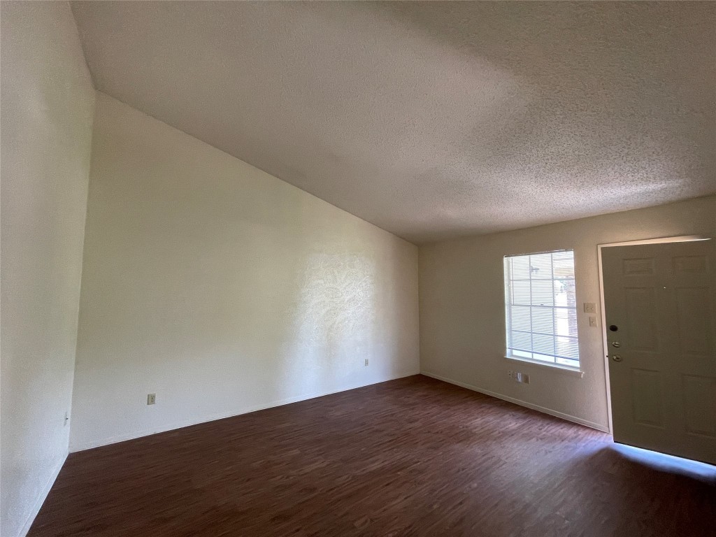 7902 Brodie Lane, Unit A Austin, TX 78745 - Photo 5 of 22 an empty room with wooden floor and windows