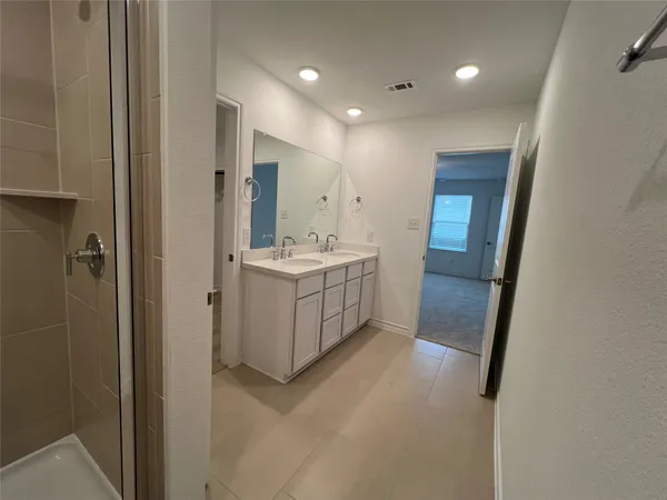 a bathroom with a double vanity sink and a mirror