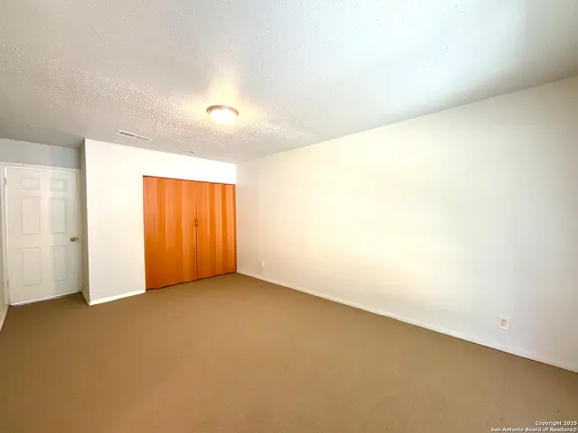 an empty room with a empty space and windows