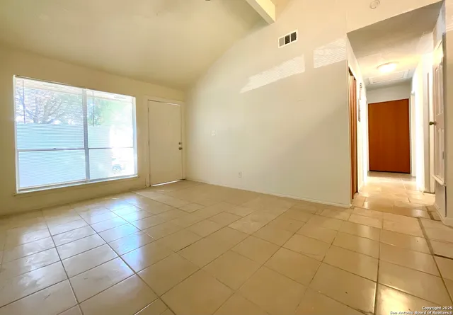 a view of an empty room with a window