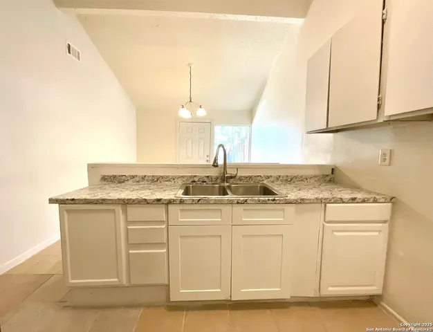 a kitchen with a refrigerator and a stove
