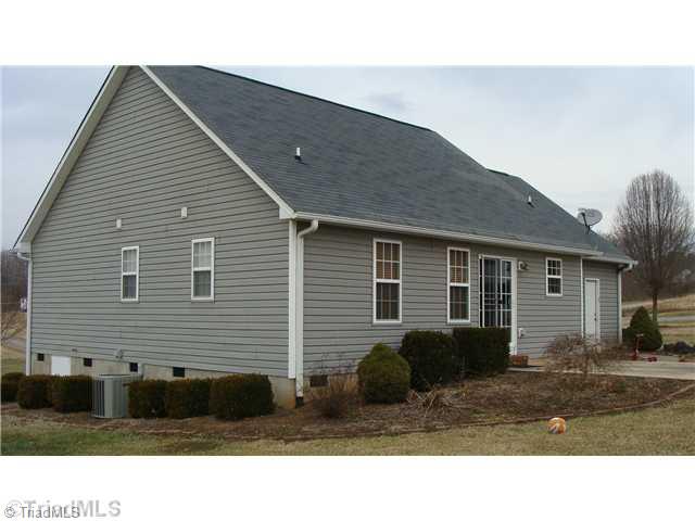 2814 Cartwright Road Boonville, NC 27011 - Photo 11 of 11 Exterior Back. Spacious neighborhood with elbo room for your family. Great Patio!!