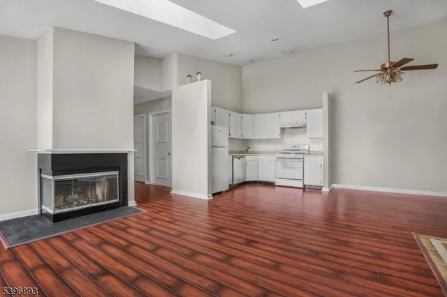 a view of a livingroom with wooden floor and a fireplace